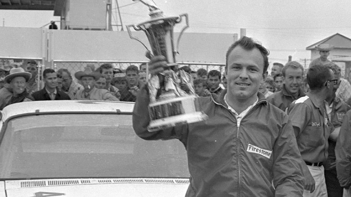 FILE - In this Feb. 14, 1965, file photo, Fred Lorenzen, of Elmhurst, Ill., gives a victory wave after winning the Daytona 500 mile stock car auto race which was halted by rain at the end of 133 laps, in Daytona Beach, Fla.