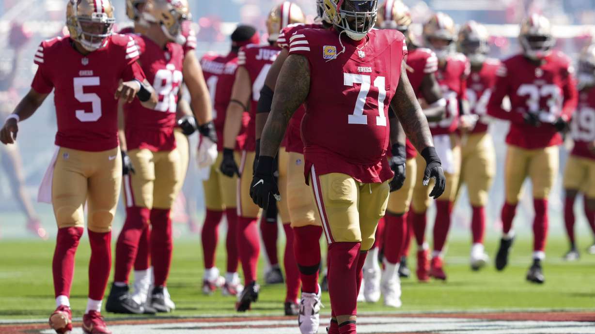 FILE - San Francisco 49ers offensive tackle Trent Williams (71) and teammates take the field for an NFL football game against the New England Patriots, Sept. 29, 2024, in Santa Clara, Calif.