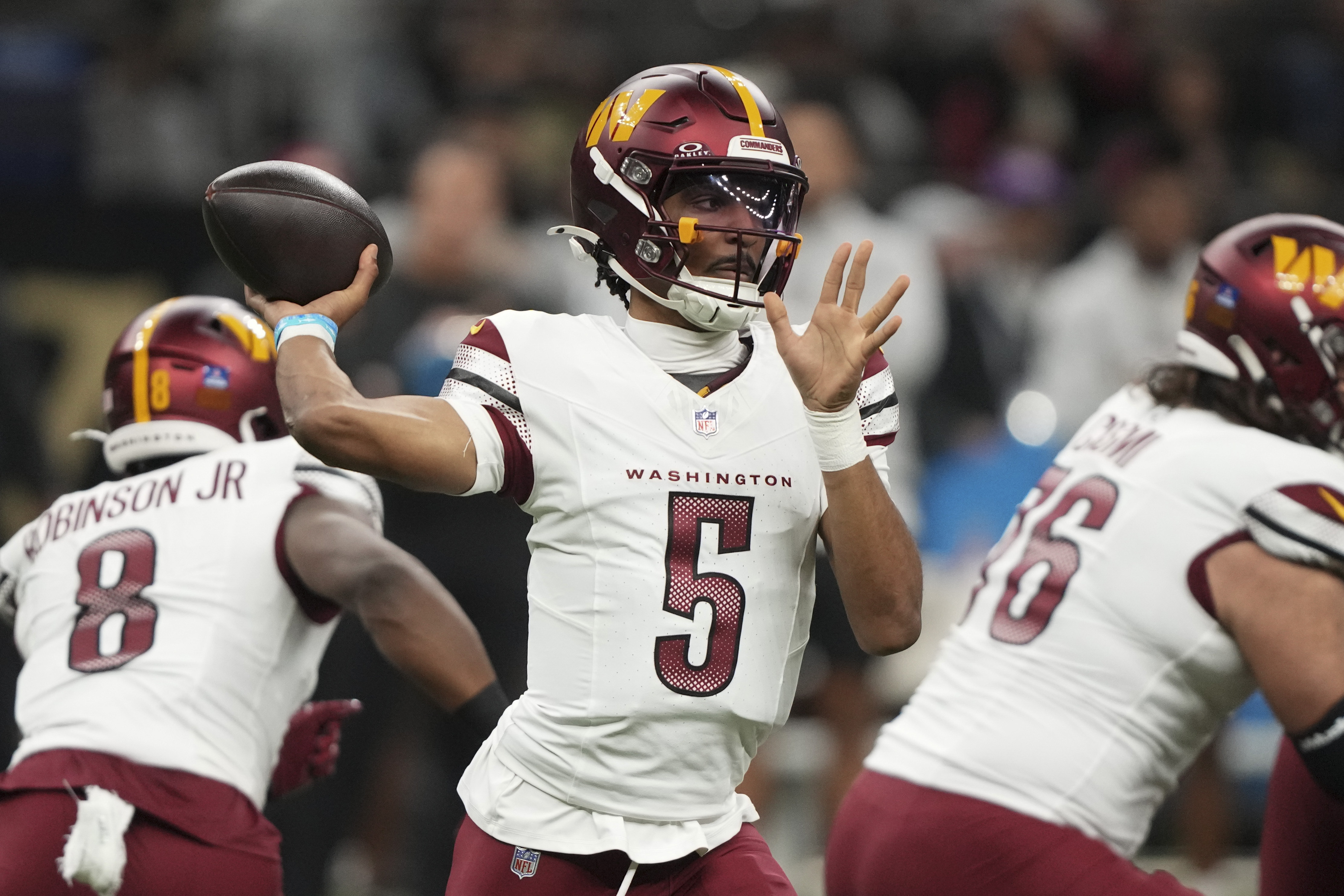 Washington Commanders quarterback Jayden Daniels (5) sets back to pass the ball in the first half of an NFL football game against the New Orleans Saints in New Orleans, Sunday, Dec. 15, 2024. 