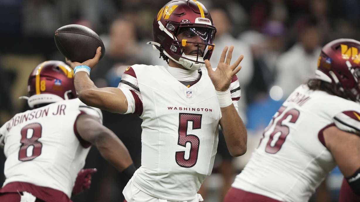 Washington Commanders quarterback Jayden Daniels (5) sets back to pass the ball in the first half of an NFL football game against the New Orleans Saints in New Orleans, Sunday, Dec. 15, 2024.