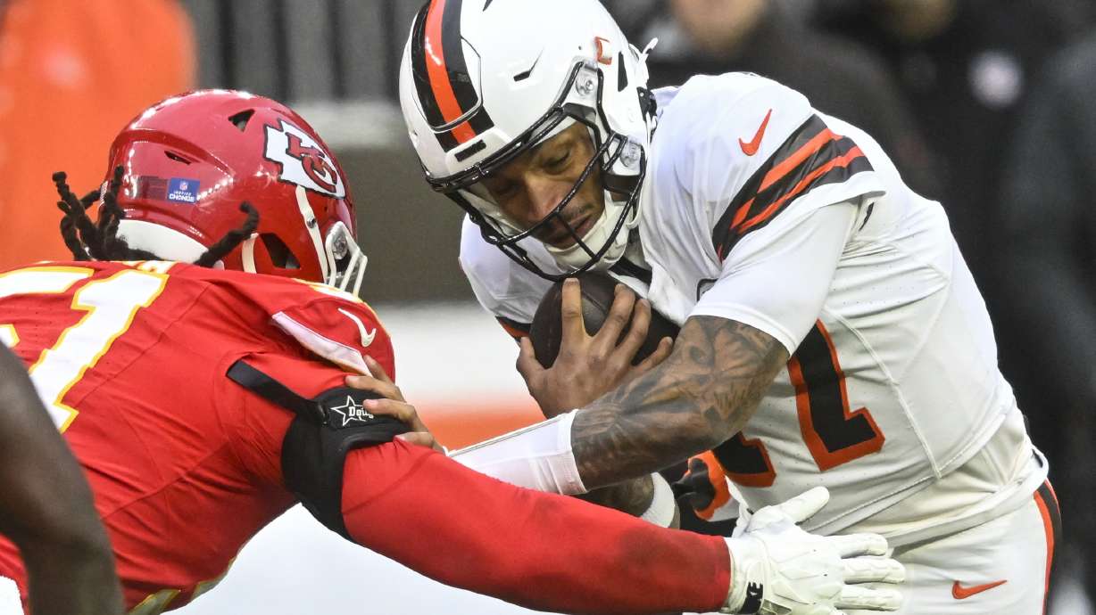 Cleveland Browns quarterback Dorian Thompson-Robinson (17) runs against Kansas City Chiefs defensive end Mike Danna (51) during the second half of an NFL football game, Sunday, Dec. 15, 2024, in Cleveland.