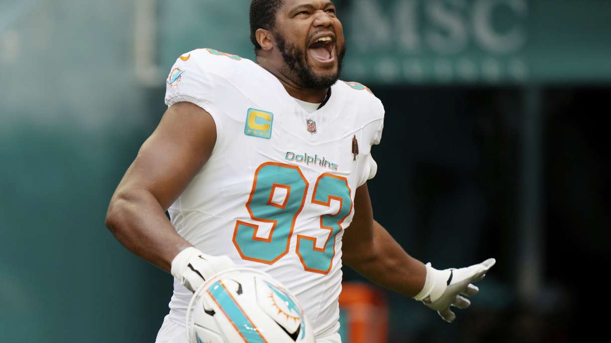 Miami Dolphins defensive tackle Calais Campbell (93) enter the field before an NFL football game against the New York Jets, Sunday, Dec. 8, 2024, in Miami Gardens, Fla.