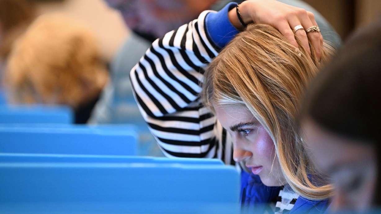 Kimberly Lilenquest rests her hand on her head as she casts her vote in Draper on Nov. 5. Trust in the election process is shifting, a new poll finds.