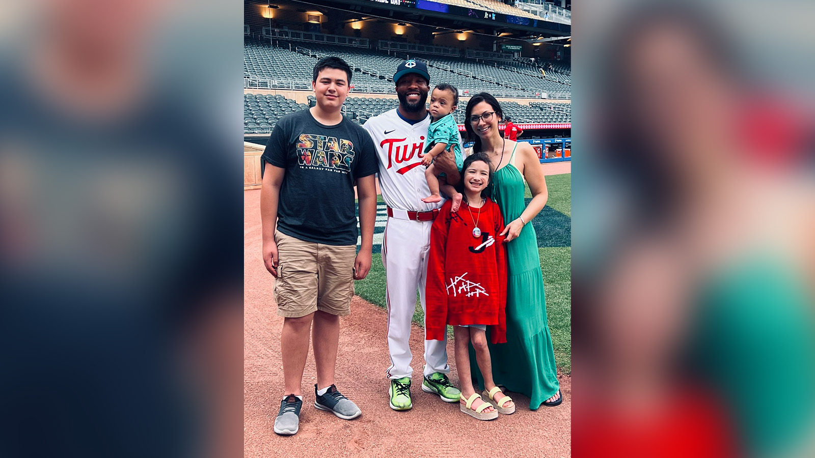 Jay Jackson and Sam Bautista with their children at Target Field in June.