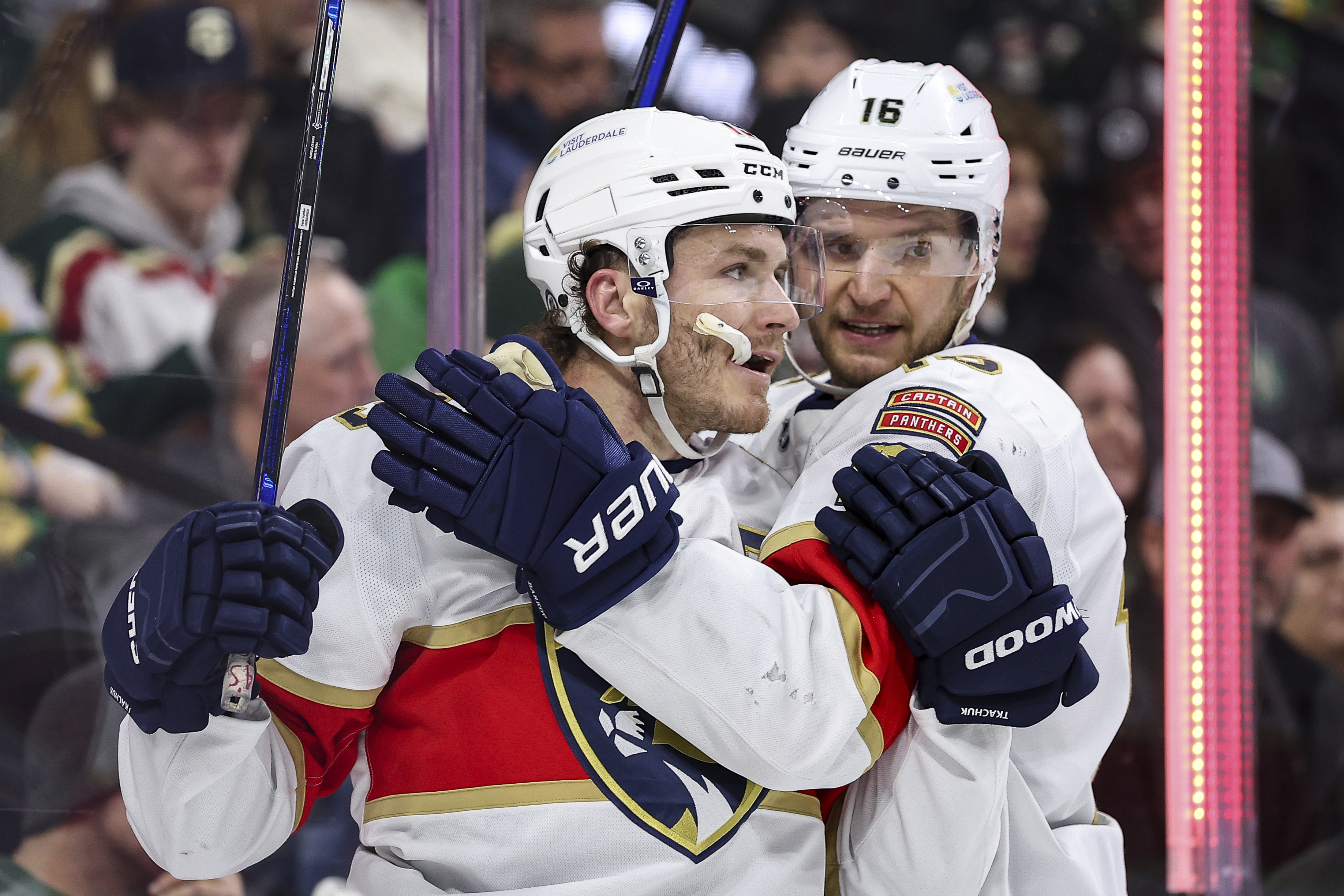 Florida Panthers left wing Matthew Tkachuk, left, celebrates his goal with center Aleksander Barkov during the second period of an NHL hockey game against the Minnesota Wild Wednesday, Dec. 18, 2024, in St. Paul, Minn.