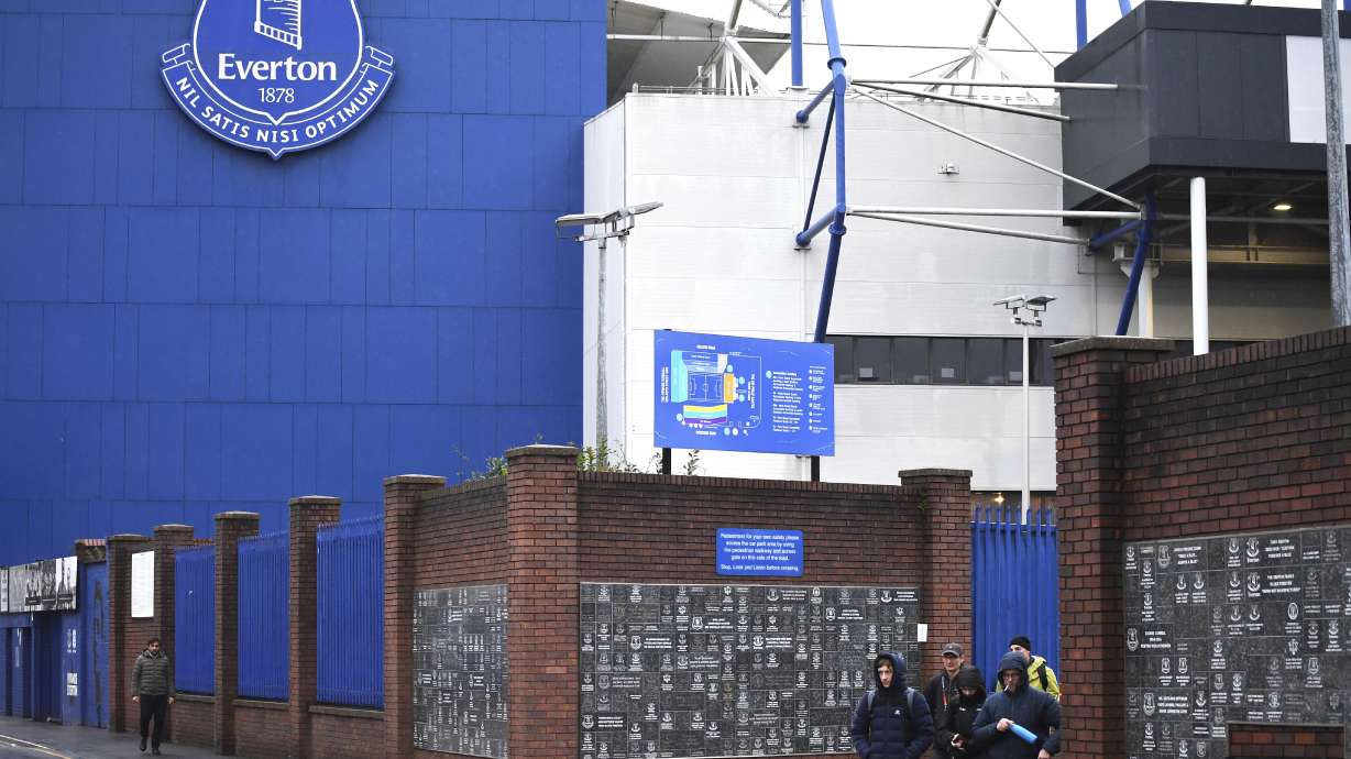 People walk outside Goodison Park as the Premier League soccer match between Everton and Liverpool is called off due to storm Darragh at Goodison Park, in Liverpool, England, Saturday Dec 7, 2024.