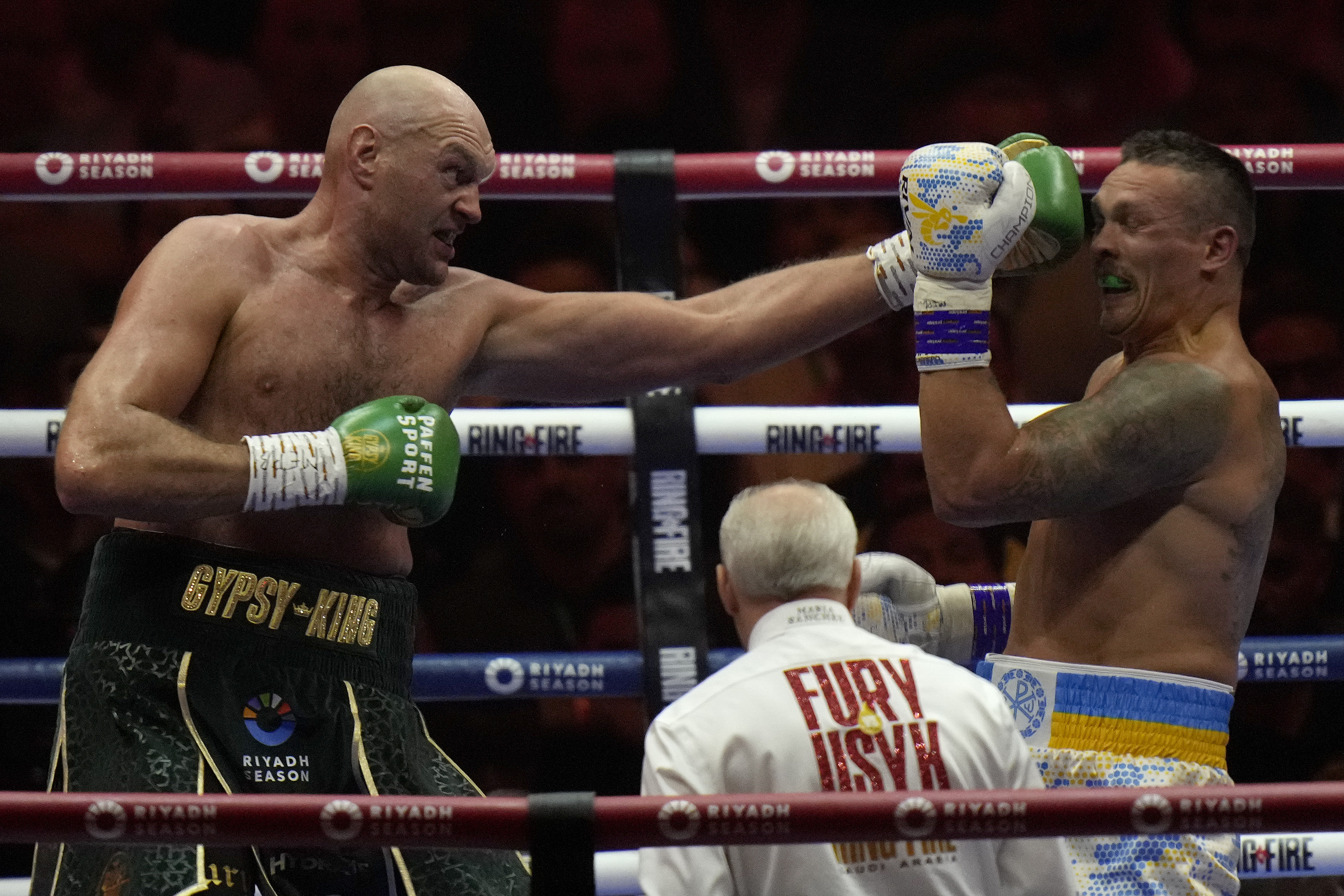 FILE - Britain's Tyson Fury, left, punches Ukraine's Oleksandr Usyk during their undisputed heavyweight world championship boxing fight at the Kingdom Arena in Riyadh, Saudi Arabia, May 19, 2024. 