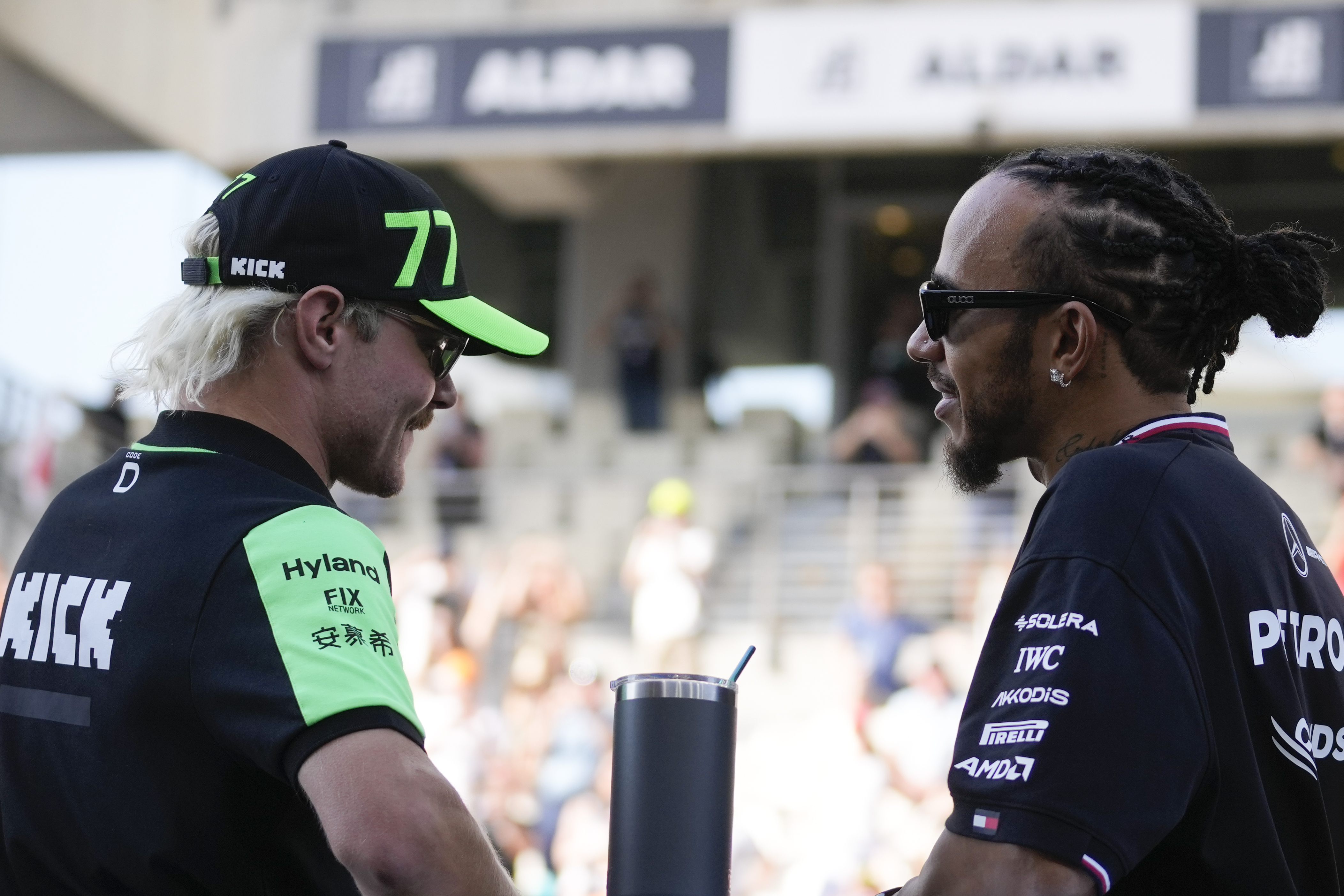 Kick Sauber driver Valtteri Bottas of Finland, left, and Mercedes driver Lewis Hamilton of Britain take part in the drivers parade before the Formula One Abu Dhabi Grand Prix at the Yas Marina Circuit in Abu Dhabi, UAE, Sunday, Dec. 8, 2024.