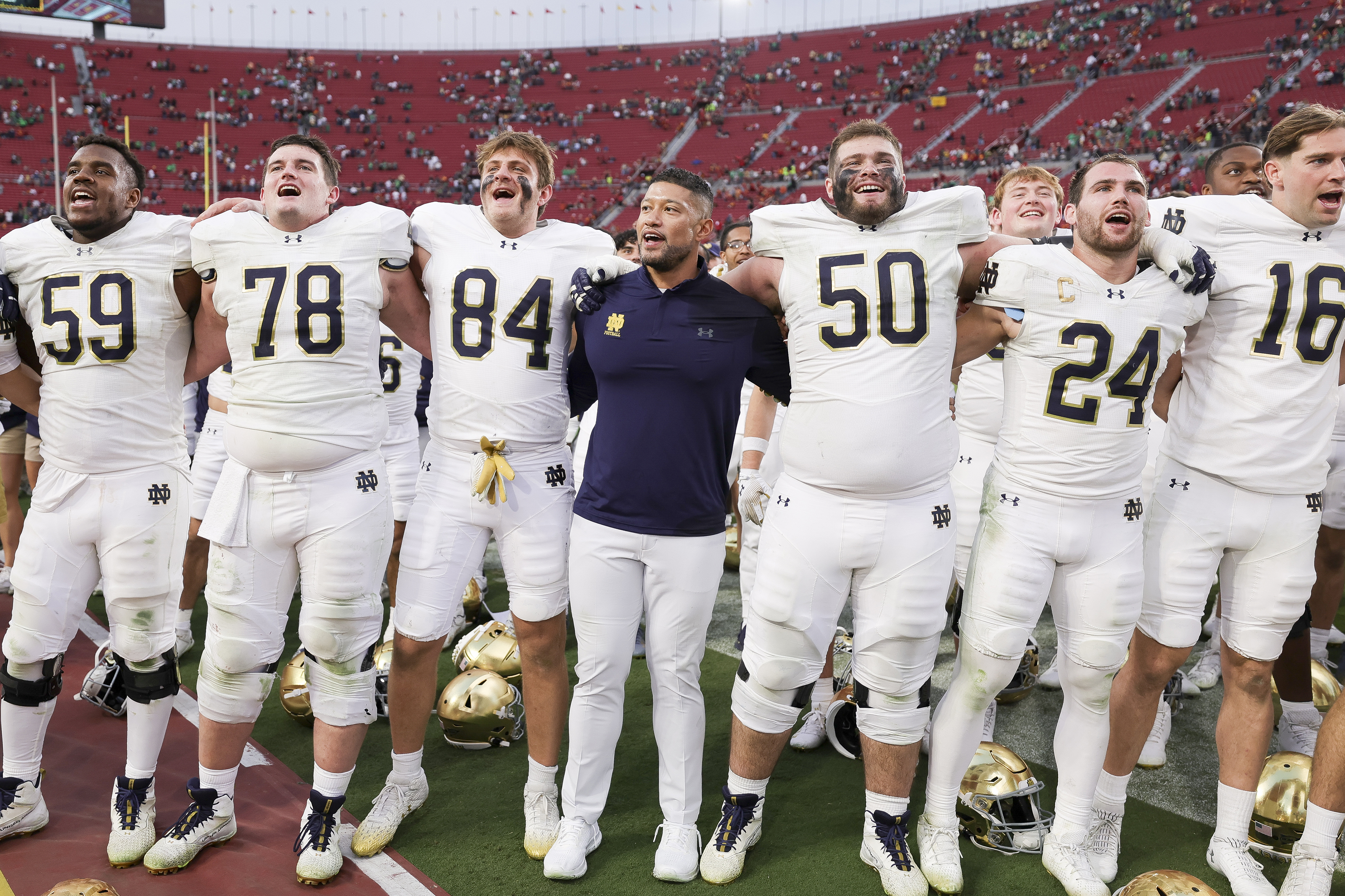 Notre Dame head coach Marcus Freeman, center, chants with his players after the team's win against Southern California in an NCAA college football game Saturday, Nov. 30, 2024, in Los Angeles. 