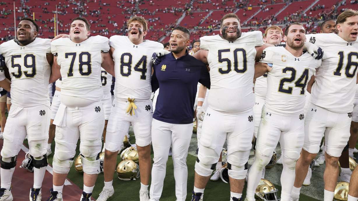 Notre Dame head coach Marcus Freeman, center, chants with his players after the team's win against Southern California in an NCAA college football game Saturday, Nov. 30, 2024, in Los Angeles.