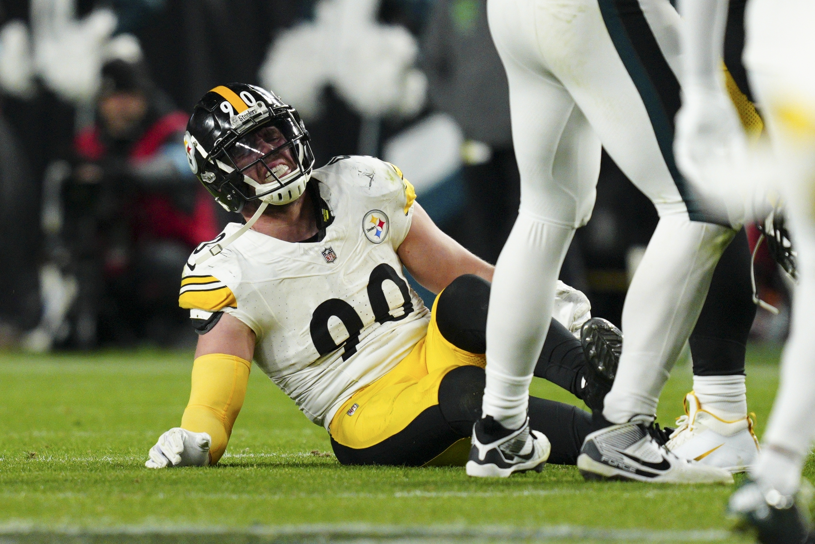 Pittsburgh Steelers linebacker T.J. Watt (90) sits on the field after an injury during the second half of an NFL football game against the Philadelphia Eagles on Sunday, Dec. 15, 2024, in Philadelphia. 