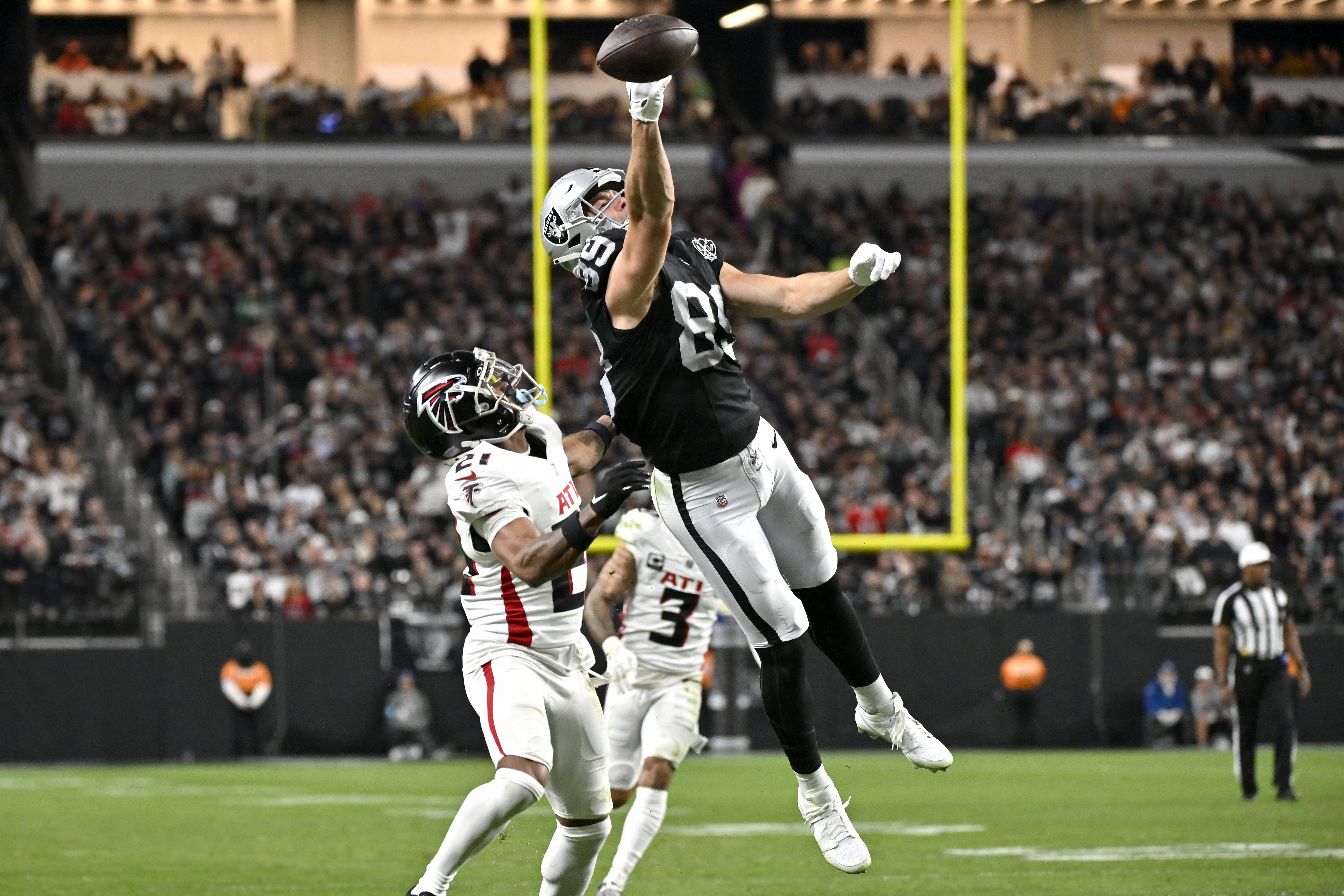 Las Vegas Raiders tight end Brock Bowers (89) can't make the catch as Atlanta Falcons cornerback Mike Hughes (21) defends during the first half of an NFL football game, Monday, Dec. 16, 2024, in Las Vegas. 