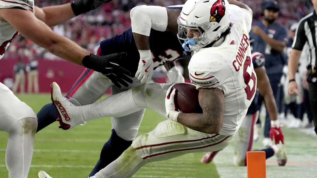 New England Patriots cornerback Jonathan Jones tackles Arizona Cardinals running back James Conner (6) during the second half of an NFL football game, Sunday, Dec. 15, 2024, in Glendale, Ariz.
