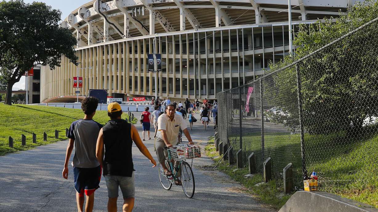 FILE - In this Aug. 5, 2017, file photo people make their way to RFK Stadium in Washington before an MLS soccer match between D.C. United and Toronto FC.