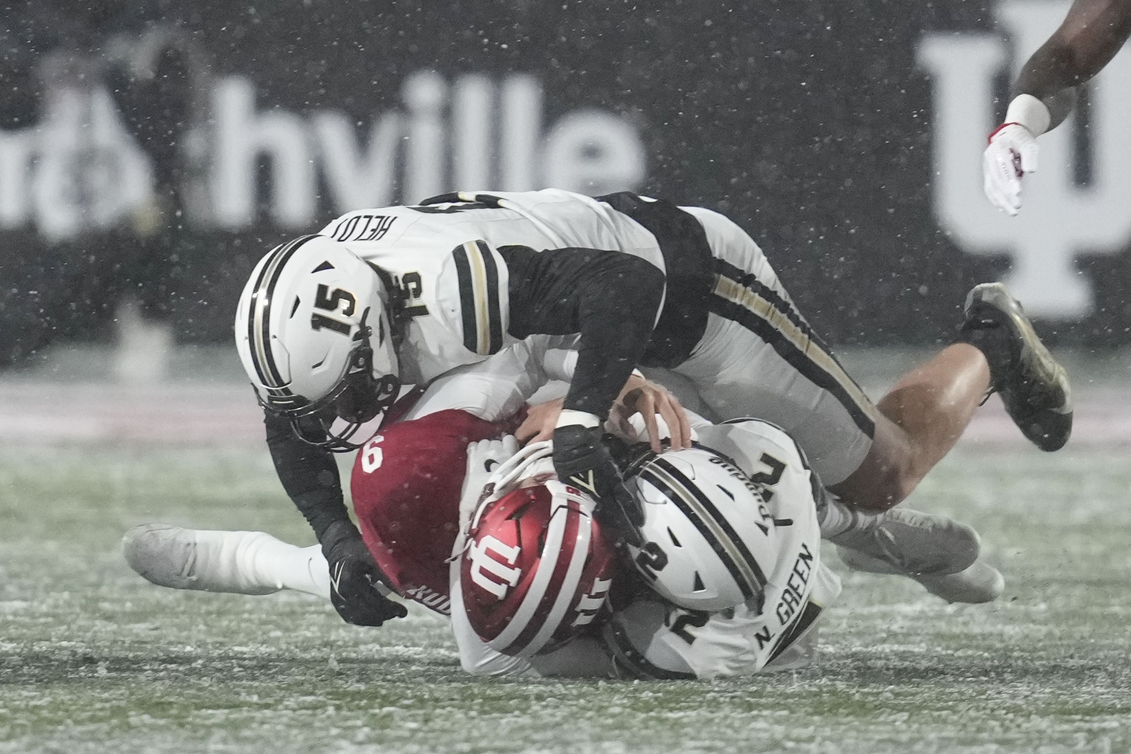 Indiana quarterback Kurtis Rourke (9) is sacked by Purdue defensive back Nyland Green (2) and defensive end Will Heldt (15) during the first half of an NCAA college football game, Saturday, Nov. 30, 2024, in Bloomington, Ind. 