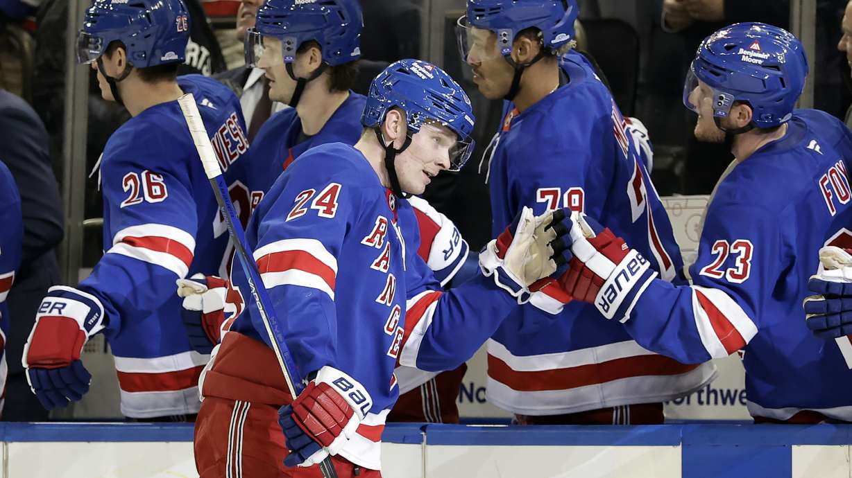 New York Rangers right wing Kaapo Kakko (24) celebrates with teammates after scoring a goal in the third period of an NHL hockey game against the Montreal Canadiens Saturday, Nov. 30, 2024, in New York. The Rangers won 4-3.