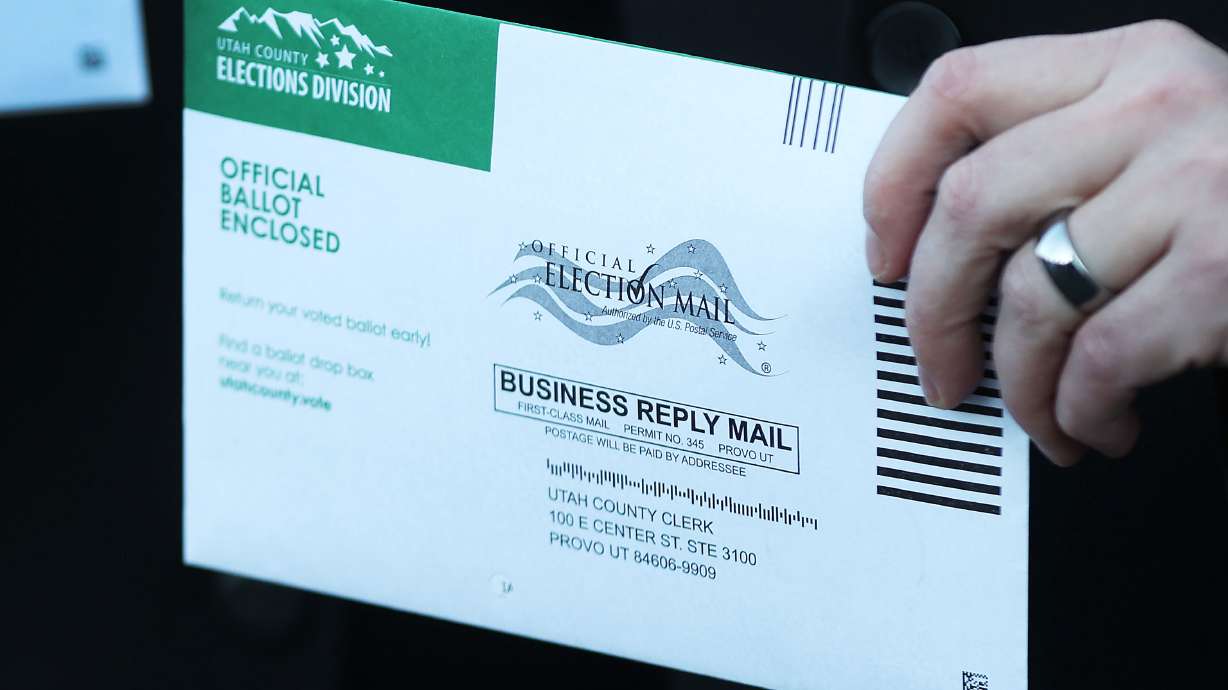 A voter holds a mail-in ballot in Provo on Nov. 4, 2022. During Utah Gov. Spencer Cox's monthly news conference Thursday, Cox reaffirmed his support for mail-in voting.