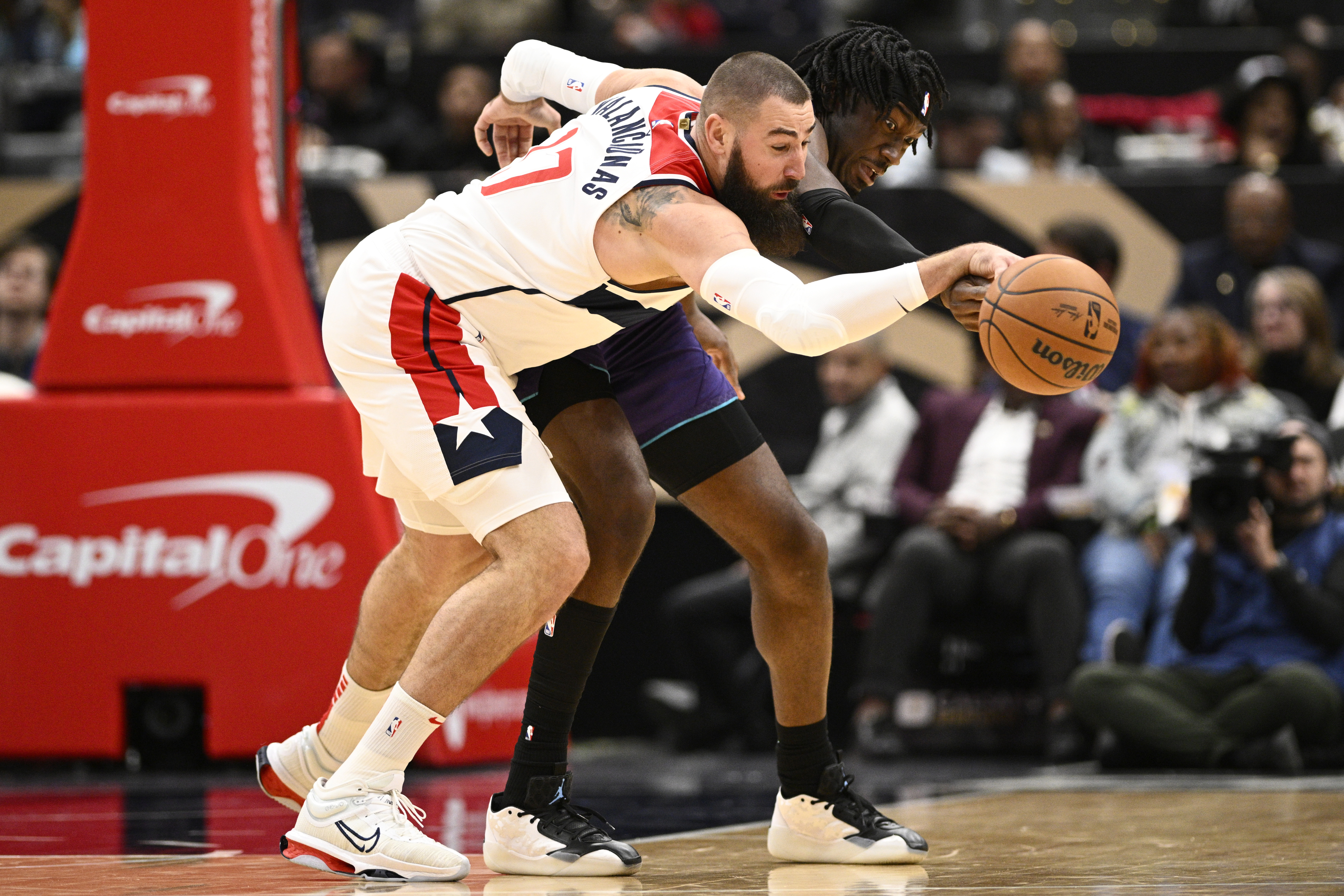 Washington Wizards center Jonas Valanciunas, left, and Charlotte Hornets center Mark Williams, right, battle for the ball during the first half of an NBA basketball game, Thursday, Dec. 19, 2024, in Washington.