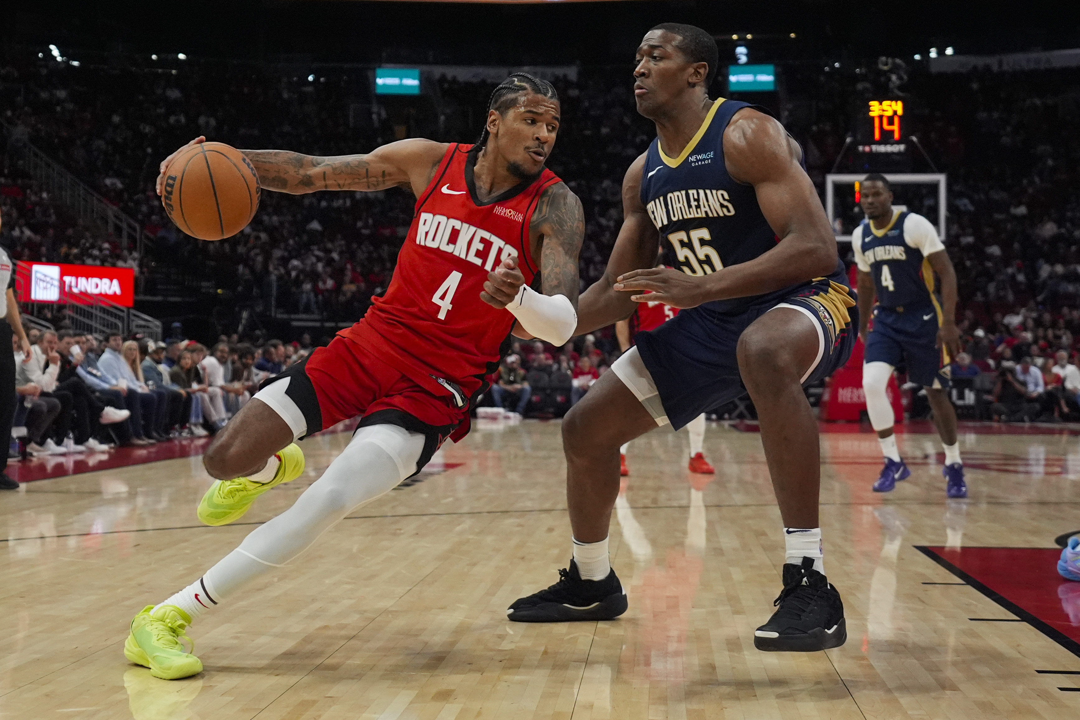Houston Rockets guard Jalen Green (4) controls the ball against New Orleans Pelicans center Trey Jemison III (55) during the first half of an NBA basketball game in Houston, Thursday, Dec. 19, 2024. 