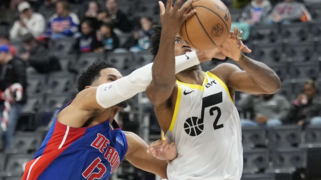 Detroit Pistons forward Tobias Harris (12) reaches in on Utah Jazz guard Collin Sexton (2) during the second half of an NBA basketball game, Thursday, Dec. 19, 2024, in Detroit.