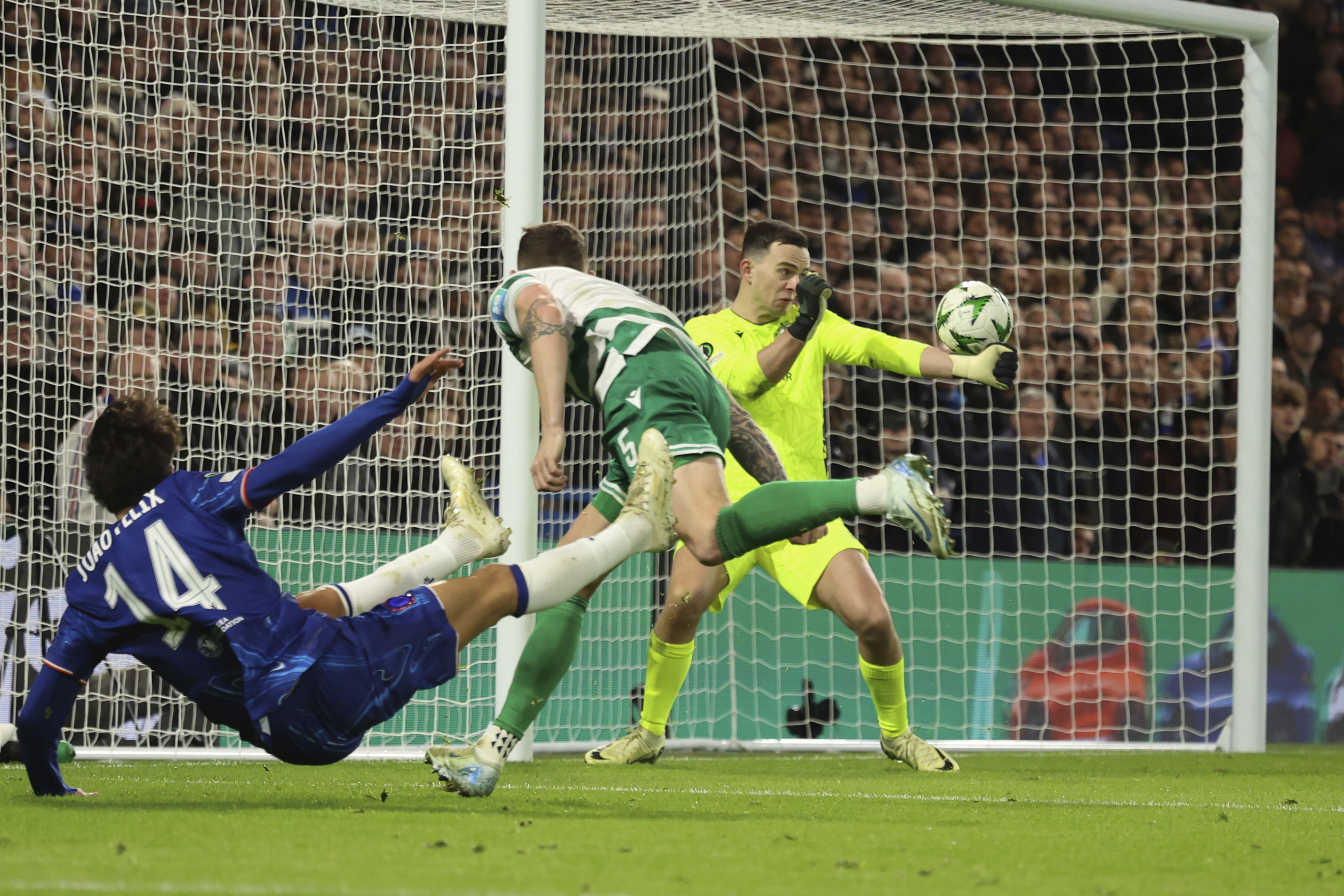 Shamrock Rovers' goalkeeper Leon Poehls, back, blocks a shot by Chelsea's Joao Felix during the Europa Conference League opening phase soccer match between Chelsea and Shamrock Rovers at Stamford Bridge stadium in London, Thursday, Dec. 19, 2024.