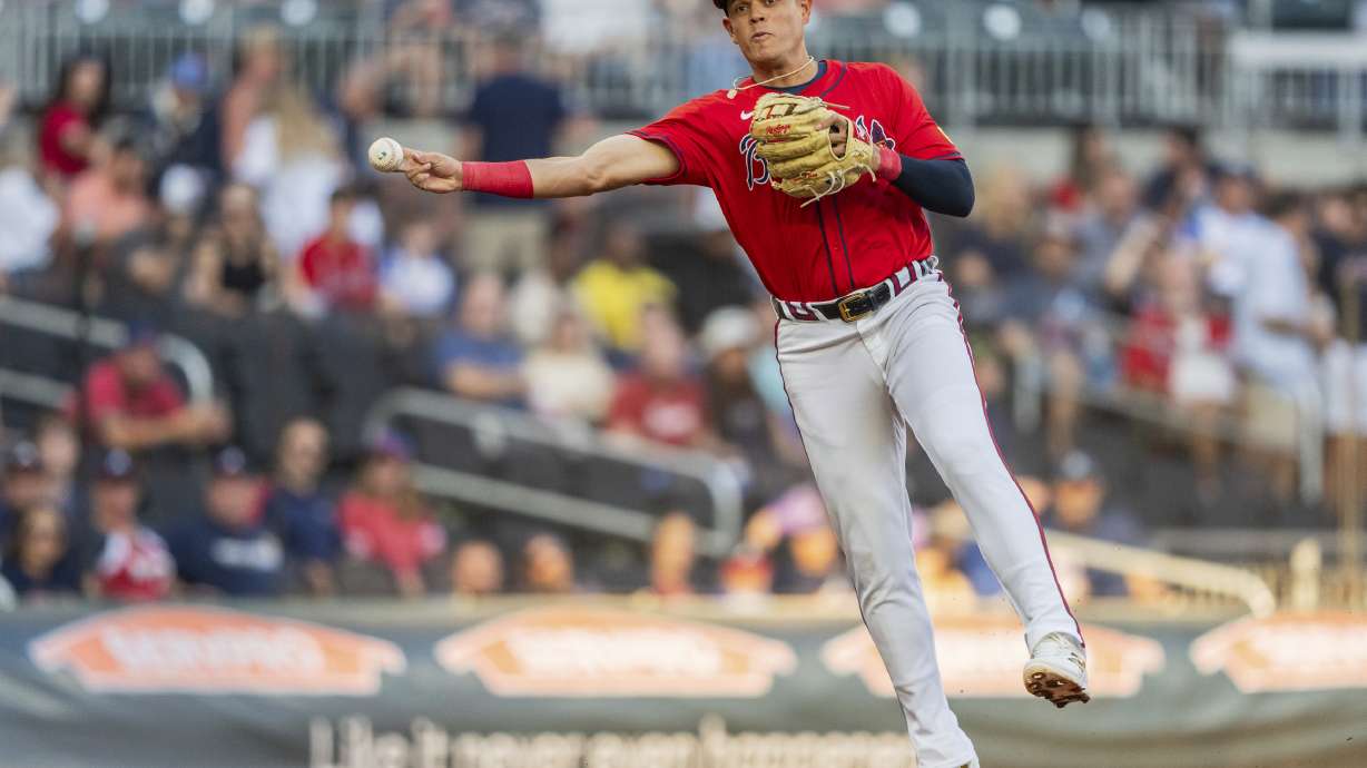 FILE - Atlanta Braves third baseman Gio Urshela throws out a Washington Nationals runner at first base in the first inning of a baseball game Friday, Aug. 23, 2024, in Atlanta.