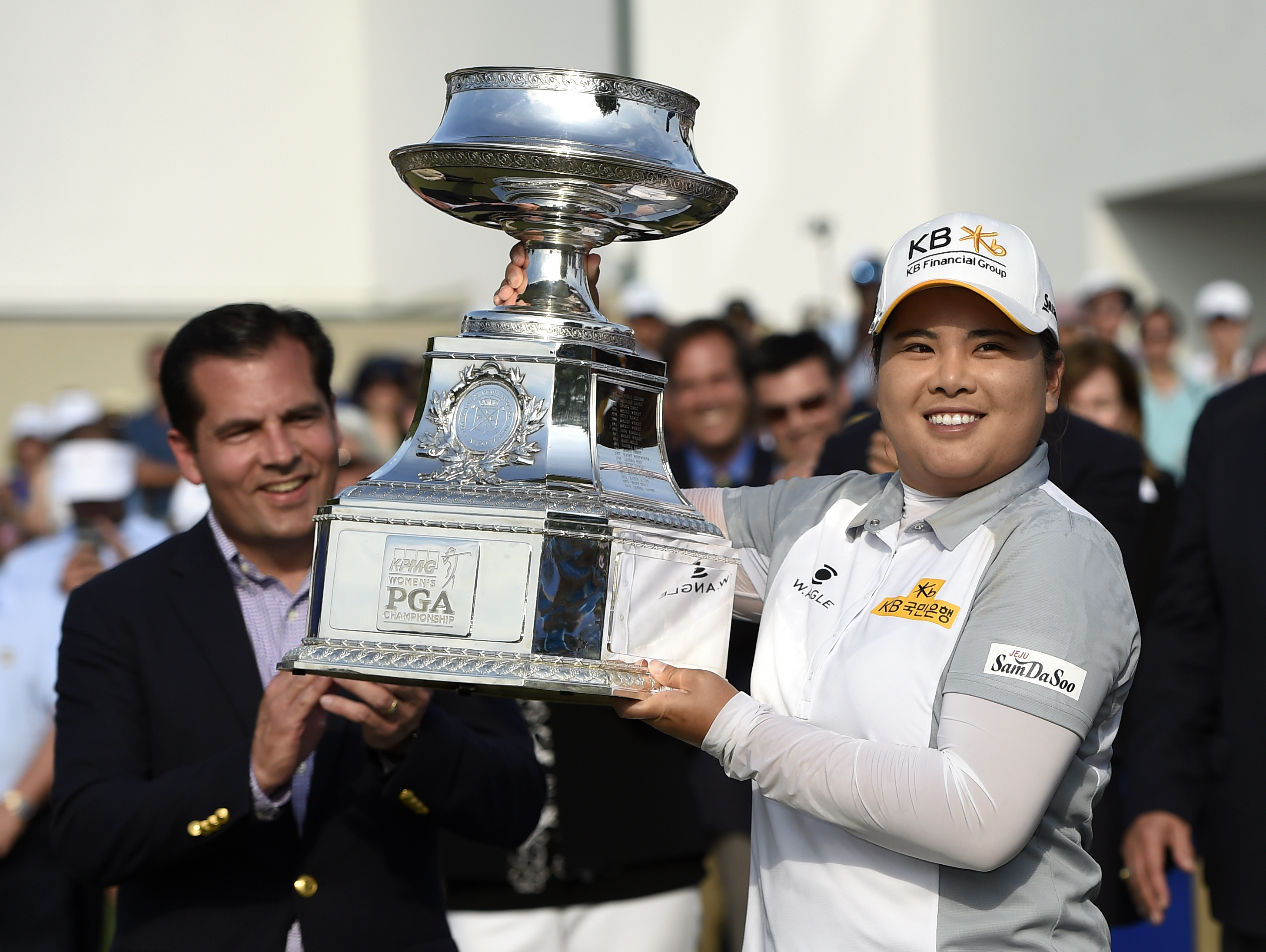 FILE - Derek Sprague, President of the PGA of America, applauds as Inbee Park of South Korea raises the KPMG Women's PGA golf championship trophy at Westchester Country Club Sunday, June 14, 2015, in Harrison, N.Y.