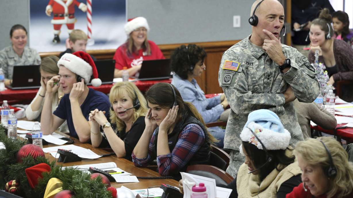 NORAD Chief of Staff Maj. Gen. Charles D. Luckey takes a call while volunteering at the NORAD Tracks Santa center at Peterson Air Force Base in Colorado Springs, Colo. on Dec. 24, 2014.