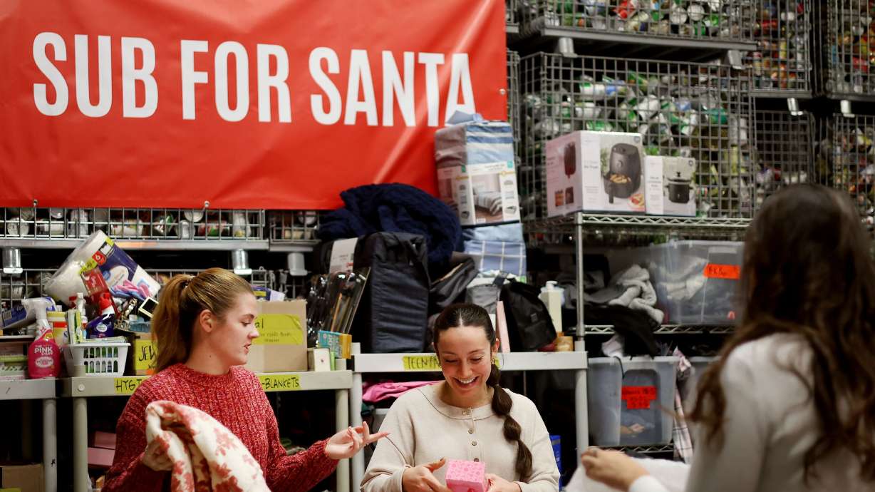 United Way employees organize donations for the United Way’s Sub For Santa program in Provo on Dec. 11.