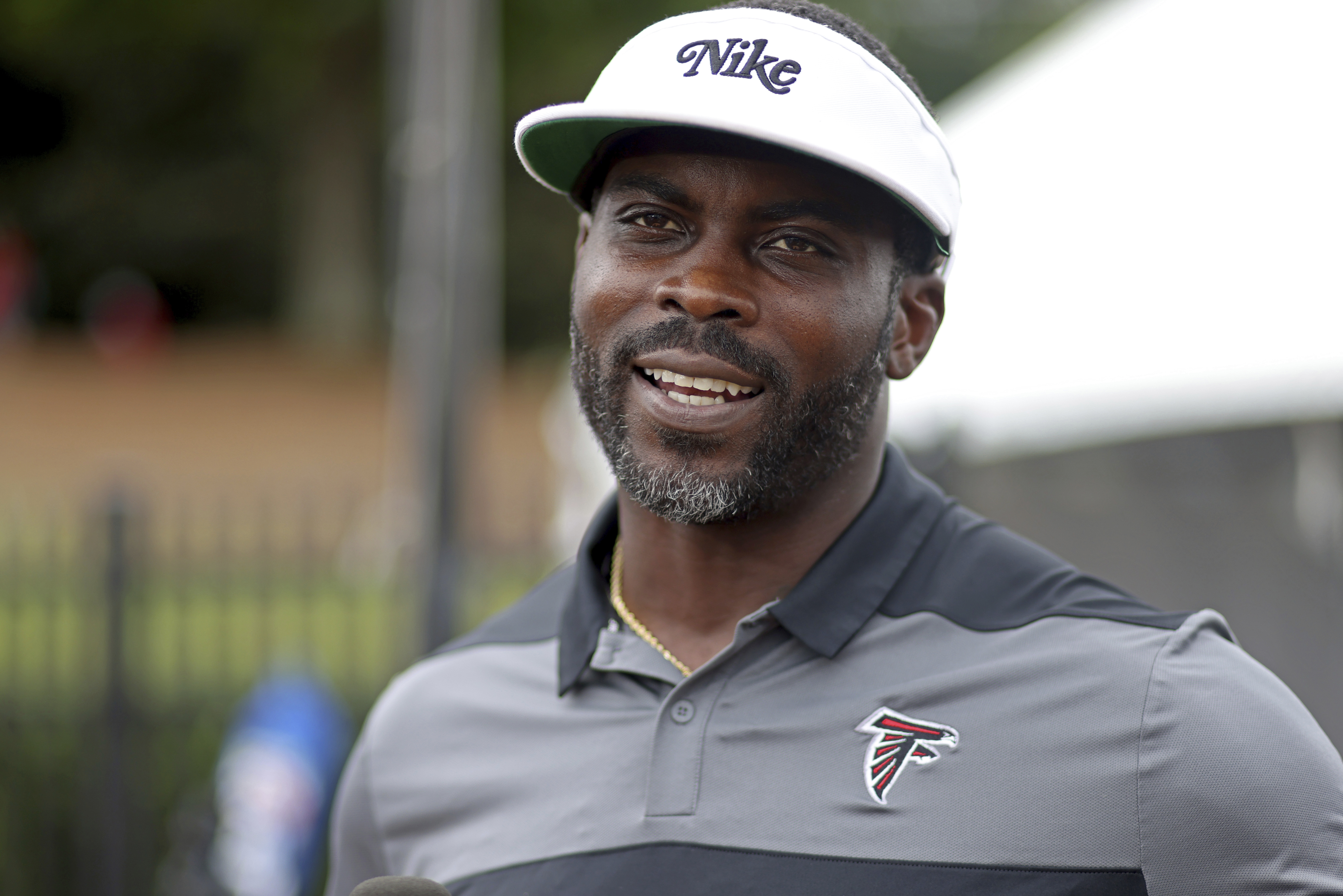 FILE - Former Atlanta Falcons quarterback Michael Vick speaks to members of the media during NFL football training camp at the team's practice facility in Flowery Branch, Ga., Wednesday, Aug. 10, 2022. /Atlanta Journal-Constitution via AP)