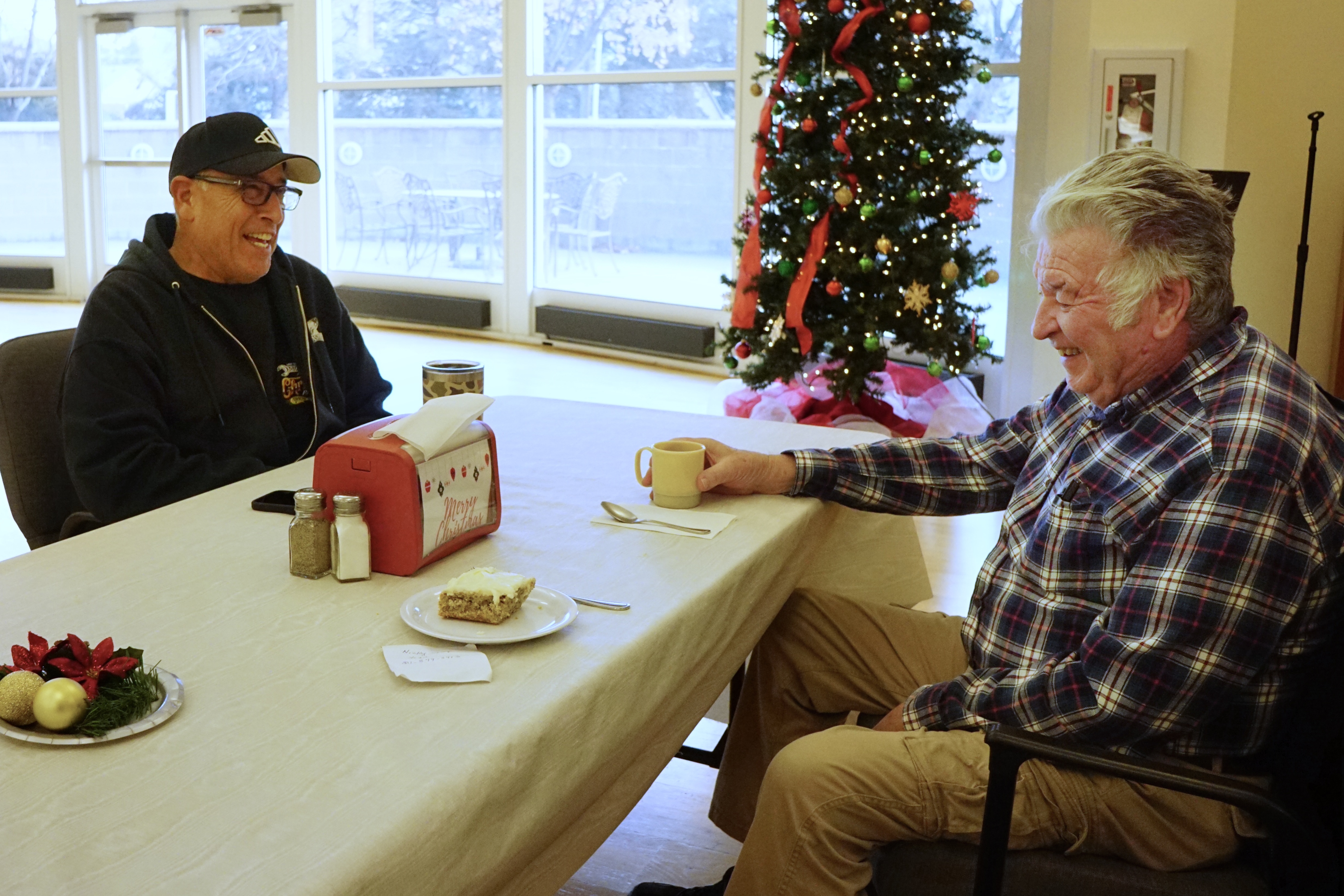 Two patrons of the Riverdale Senior Center laugh over a cup of coffee, Friday.