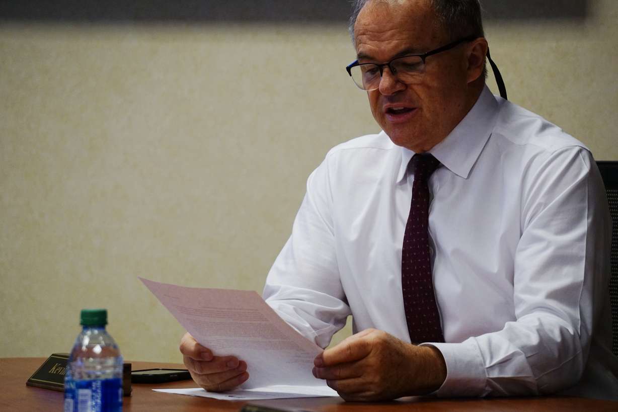 Weber Human Services CEO Kevin Eastman reads a letter from the Weber-Morgan Council on Aging, suggesting the organization adopt a four-senior center model in 2025.