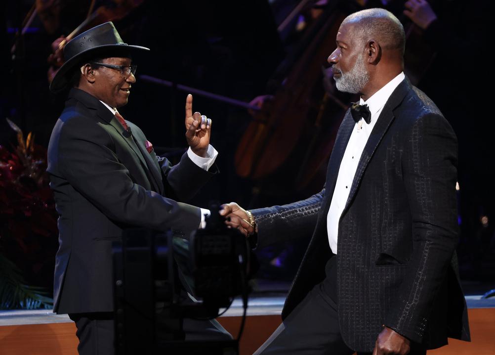 Actor Dennis Haysbert speaks with Charles Mulli, whose story is being told through his narrations, during the Tabernacle Choir's Christmas concert on Thursday.