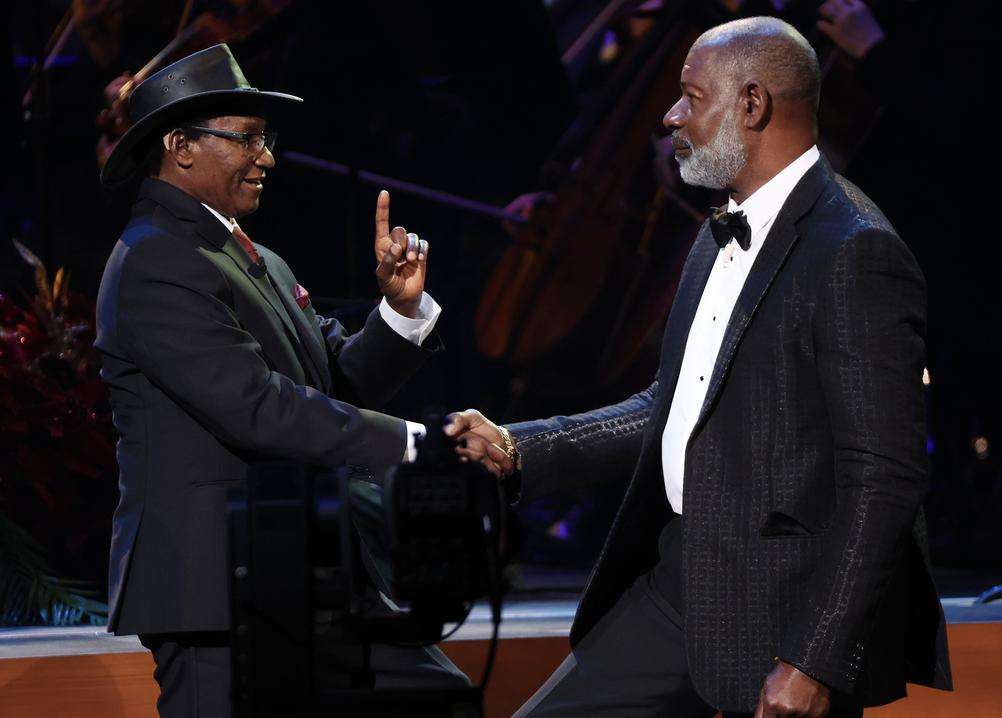 Actor Dennis Haysbert speaks with Charles Mulli, whose story is being told through his narrations, during the Tabernacle Choir's Christmas concert on Thursday.