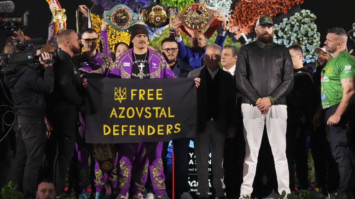 Boxers Britain's Tyson Fury, third right, and world champion Ukraine's Oleksandr Usyk, center left, stand on stage during the weigh-in for their WBA, WBO, and WBC heavyweight title bout in Riyadh, Saudi Arabia, Friday, Dec. 20, 2024.