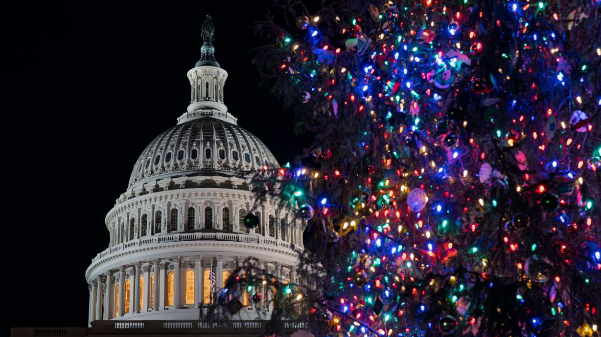 The Capitol Christmas tree is illuminated in Washington, after the Republican-controlled House of Representatives failed to pass an interim spending bill Thursday. The Senate passed a modified bill Friday to avoid a government shutdown hours before the deadline.