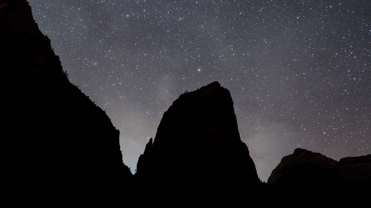 A starry night sky above the silhouette of Angels Landing at Zion National Park. It is one of 31 designated dark sky places across Utah.