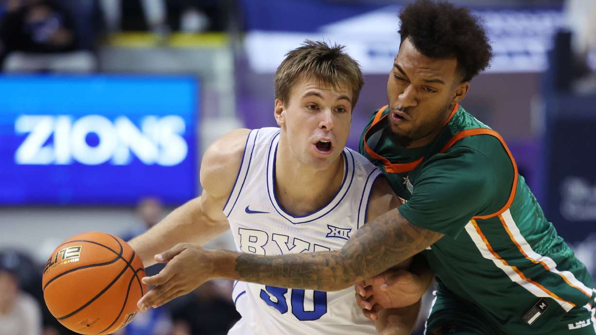 Brigham Young guard Dallin Hall (30) dribbles around Florida A&M Rattlers forward Roderick Coffee III (1) in Provo on Friday, Dec. 20, 2024.