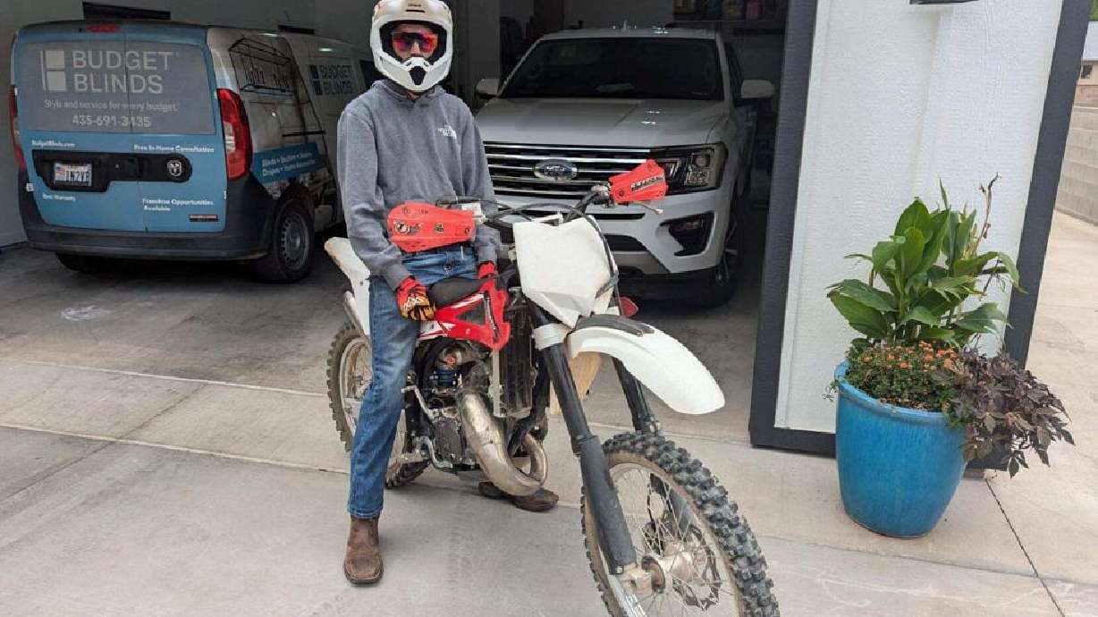 Trevor Higgins, who was involved in a serious accident just weeks ago, proudly sits on his new bike, funded by sixth graders at Washington Fields Middle School.