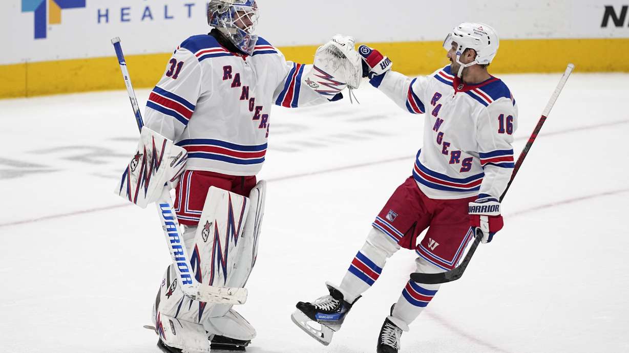 New York Rangers' Igor Shesterkin (31) and Vincent Trocheck (16) celebrate the team's win in an NHL hockey game against the Dallas Stars in Dallas, Friday, Dec. 20, 2024.