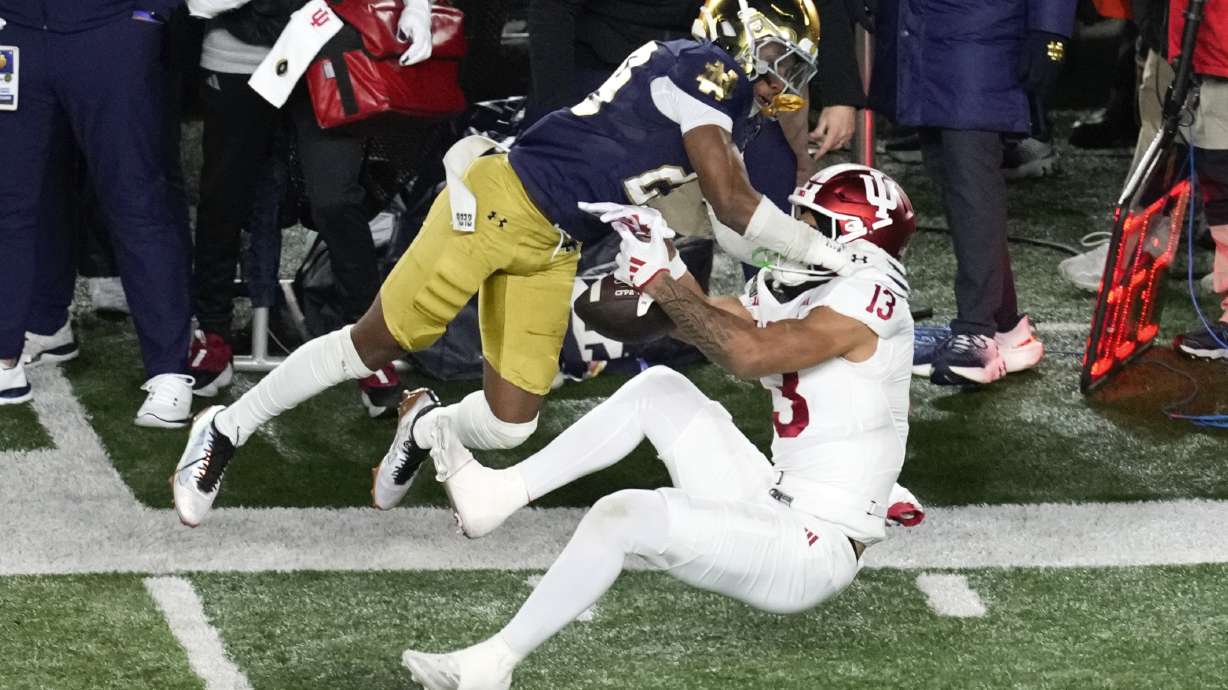 Indiana wide receiver Elijah Sarratt (13) pulls in 28-yard reception as Notre Dame cornerback Christian Gray (29) defends during the first half in the first round of the NCAA College Football Playoff, Friday, Dec. 20, 2024, in South Bend, Ind.