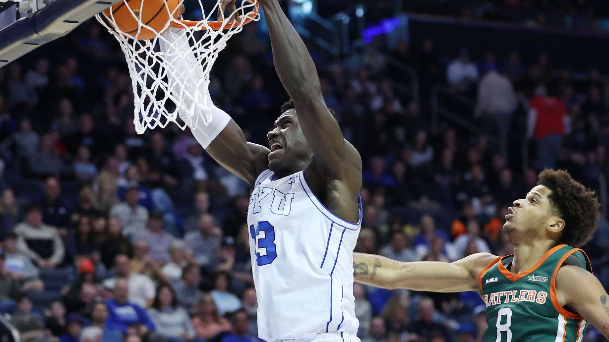 Brigham Young center Keba Keita (13) dunks Florida A&M forward Shaqir O'Neal (8) in Provo on Friday, Dec. 20, 2024. BYU won 103-57.