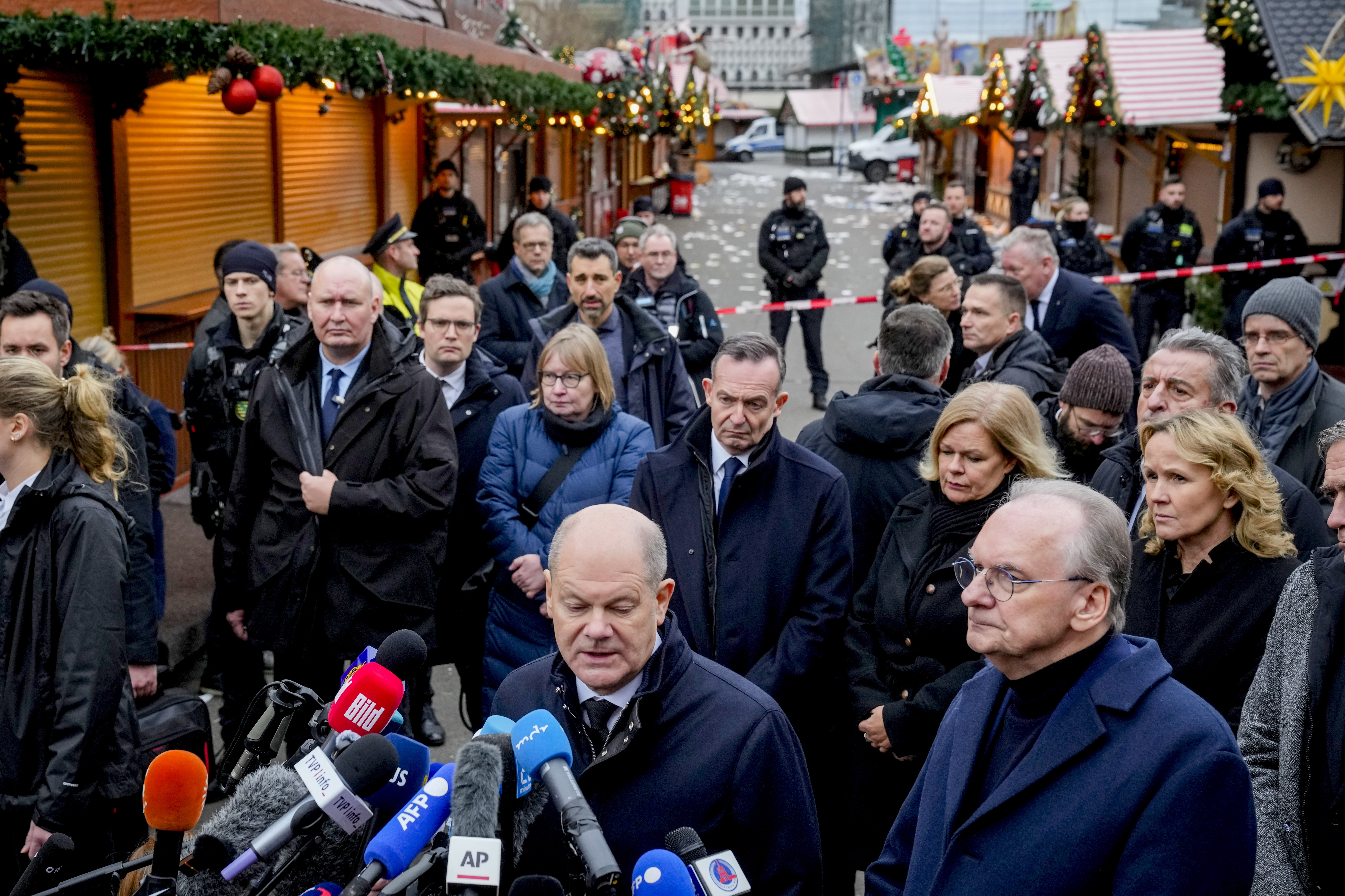 German Chancellor Olaf Scholz, center, speaks at a Christmas Market, where a car drove into a crowd on Friday evening, in Magdeburg, Germany, Saturday.
