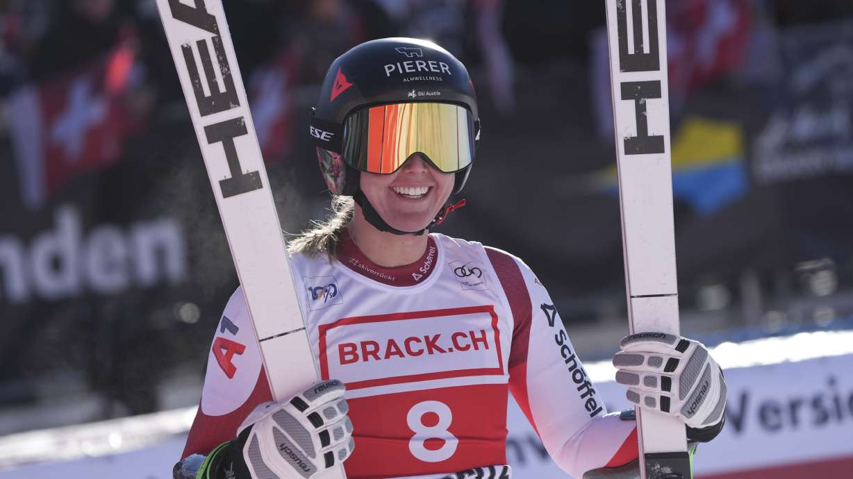 Austria's Cornelia Huetter celebrates at the finish area of an alpine ski, women's World Cup super G, in St. Moritz, Switzerland, Saturday, Dec. 21, 2024.