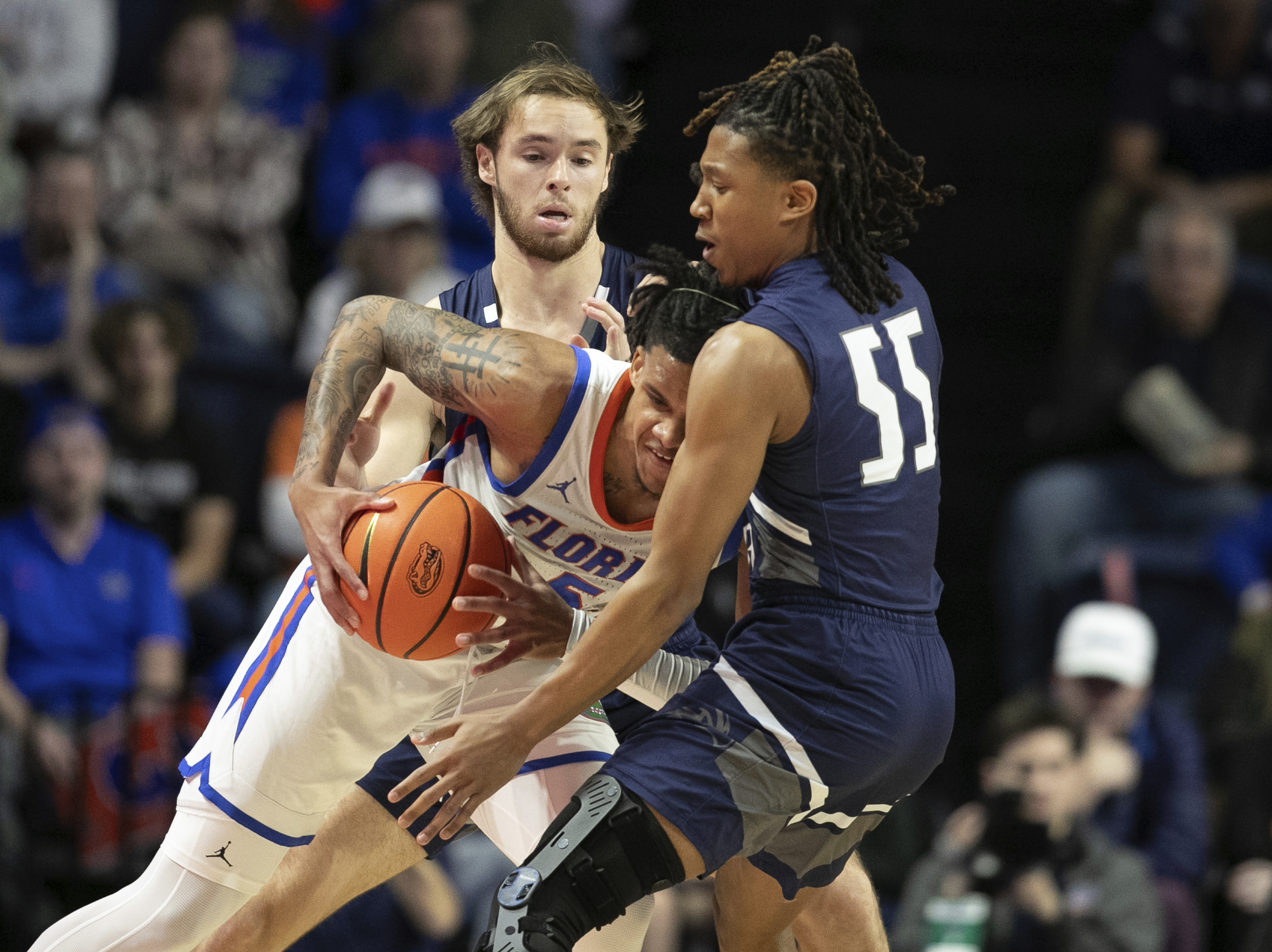 Florida guard Will Richard (5) drives against North Florida guard Ametri Moss (55) during the first half of an NCAA college basketball game Saturday, Dec. 21, 2024, in Gainesville, Fla. 