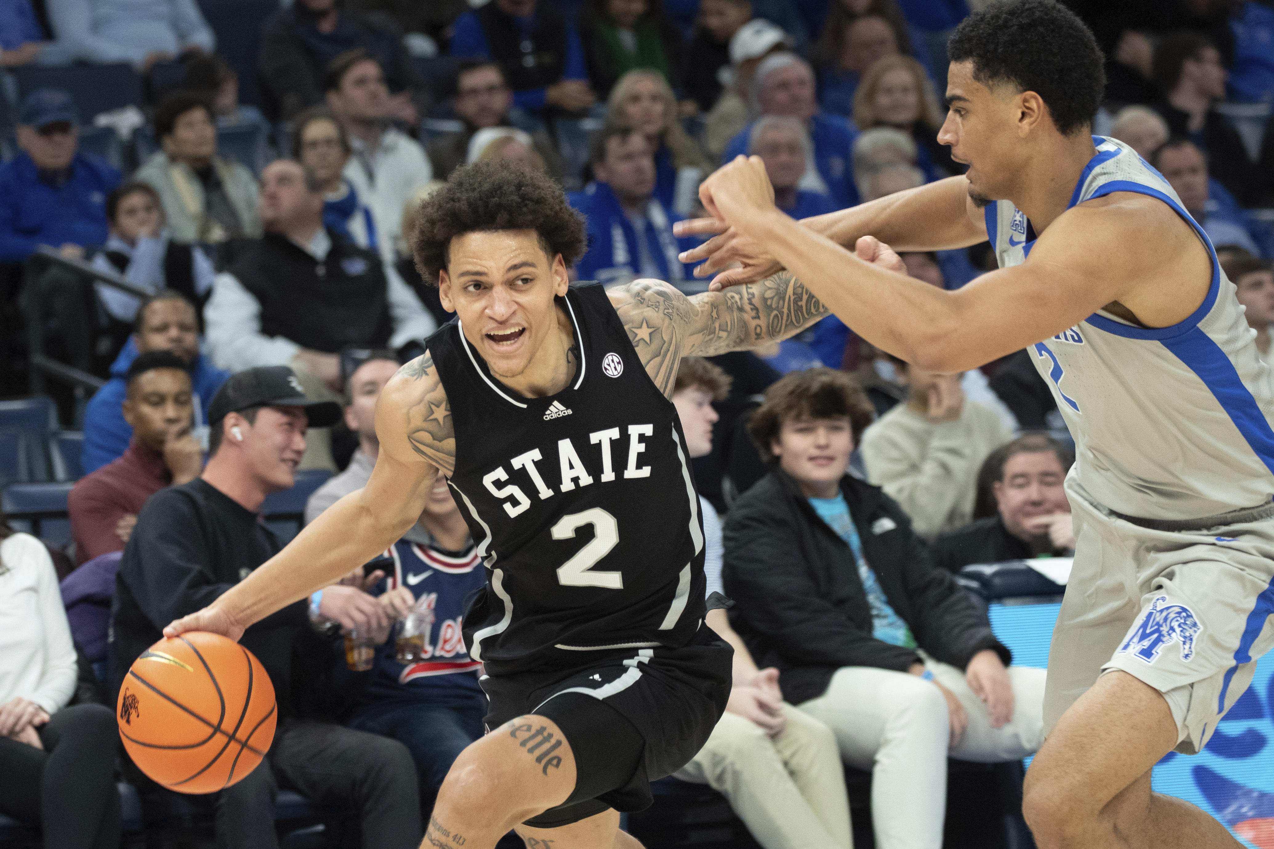 Mississippi State guard Riley Kugel (2) drives against the defense of Memphis forward Nicholas Jourdain (2) during the second half of an NCAA college basketball game Saturday, Dec. 21, 2024, in Memphis, Tenn.