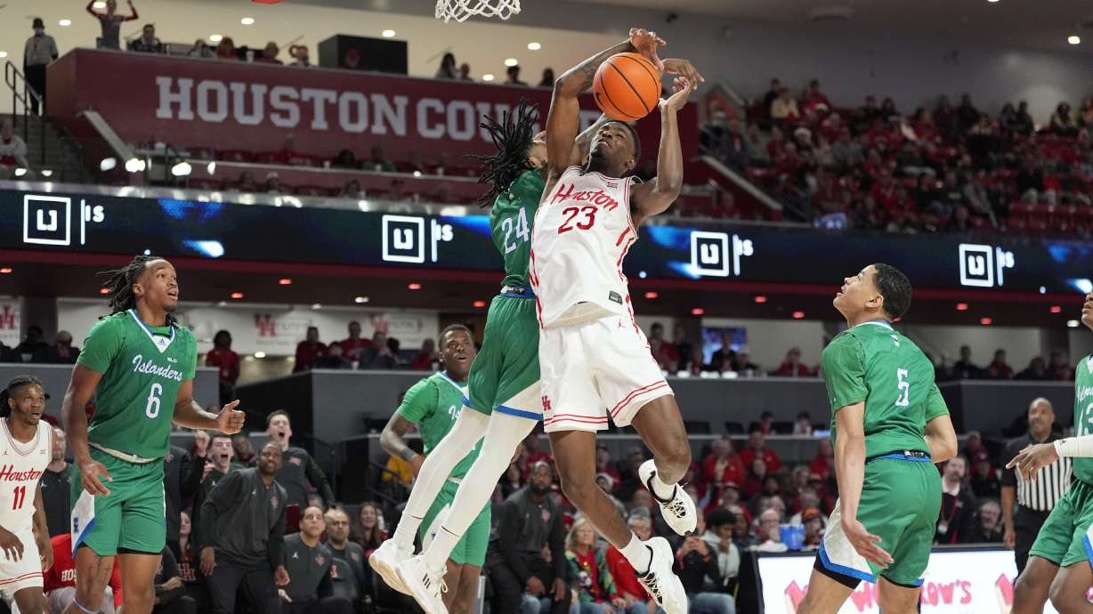 Houston's Terrance Arceneaux (23) has his shot blocked by Texas A&M-Corpus Christi's Aaron Potter (24) during the second half of an NCAA college basketball game Saturday, Dec. 21, 2024, in Houston.