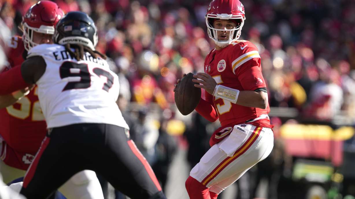 Kansas City Chiefs quarterback Patrick Mahomes drops back to pass during the first half of an NFL football game against the Houston Texans Saturday, Dec. 21, 2024, in Kansas City, Mo.