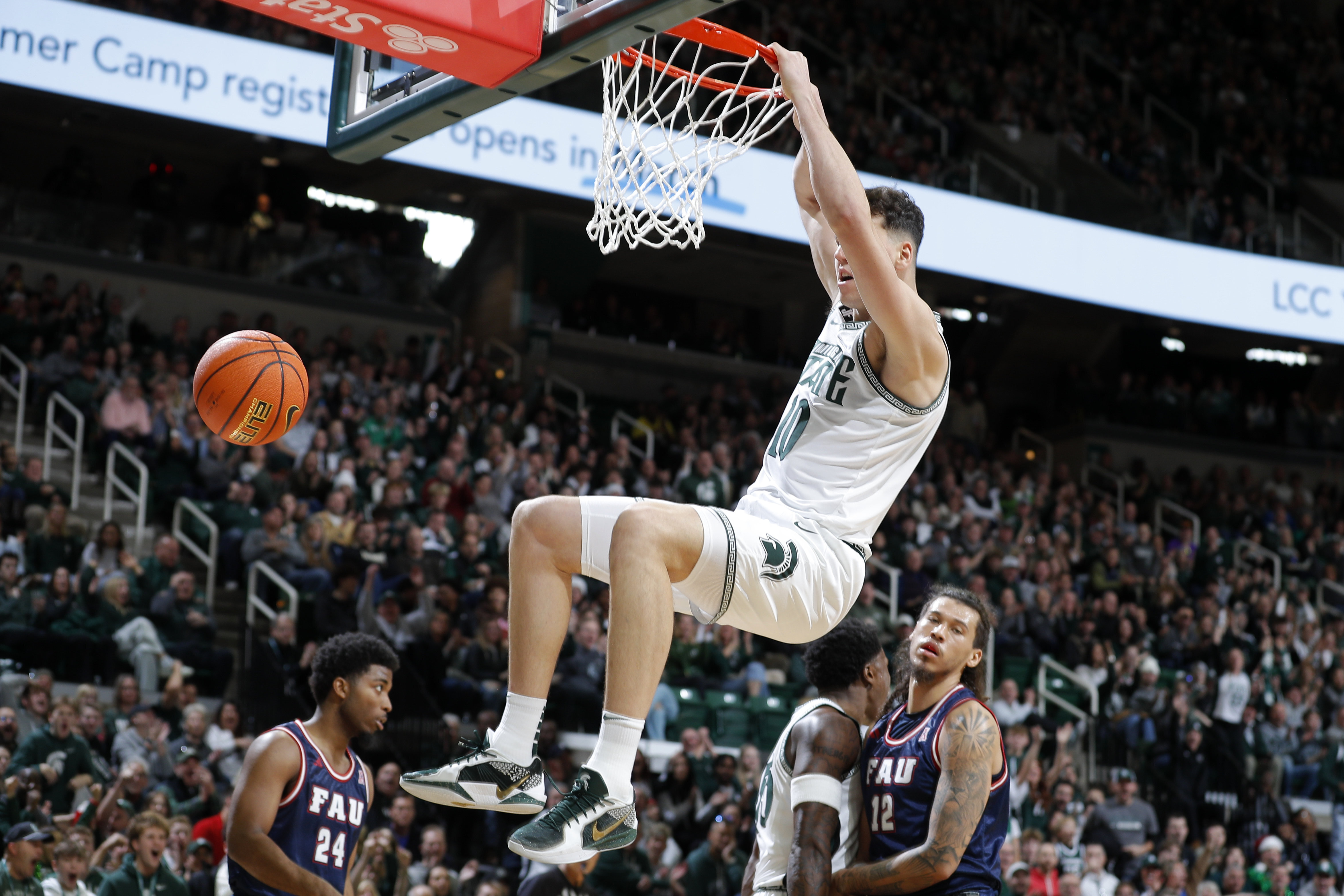 Michigan State center Szymon Zapala (10) dunks against Florida Atlantic during the first half of an NCAA college basketball game, Saturday, Dec. 21, 2024, in East Lansing, Mich. 