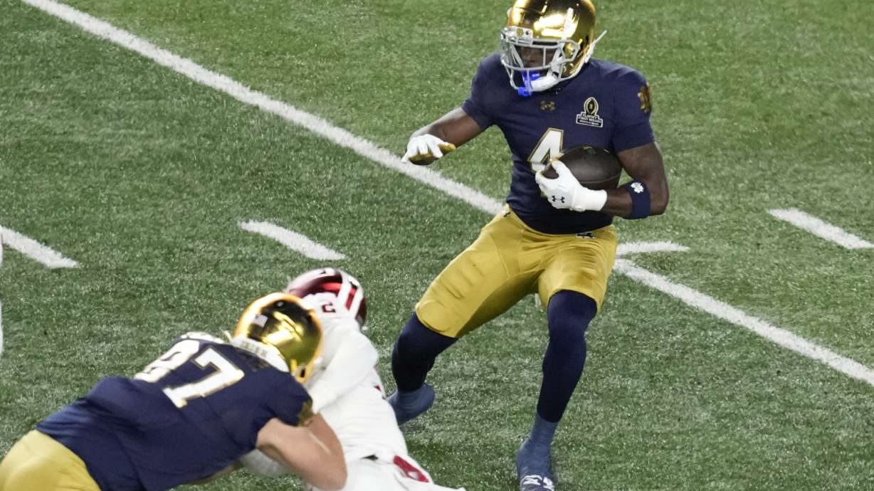 Notre Dame running back Jeremiyah Love (4) runs the ball against Indiana during the first half in the first round of the NCAA College Football Playoff, Friday, Dec. 20, 2024, in South Bend, Ind.